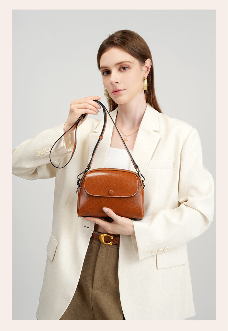 Front view of model with caramel crossbody bag styled crossbody