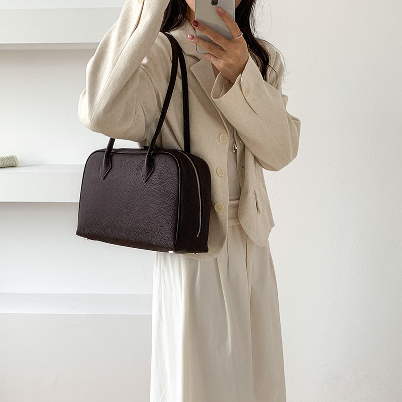 Coffee brown Boston bag carried on the shoulder