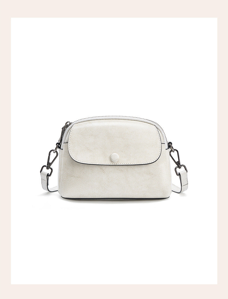 Pearl white cowhide crossbody bag with metal clip detail