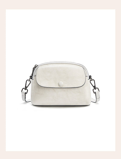 Pearl white cowhide crossbody bag with metal clip detail