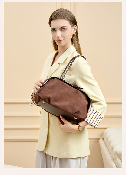 Model carrying the brown shoulder bag over one shoulder