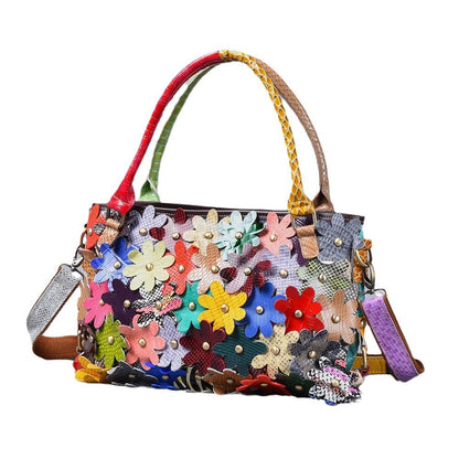 Colorful flower applique leather handbag shown against a white background