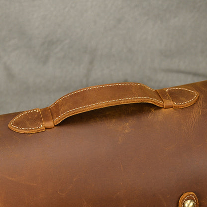 Close-up of the stitched top handle on the leather bag