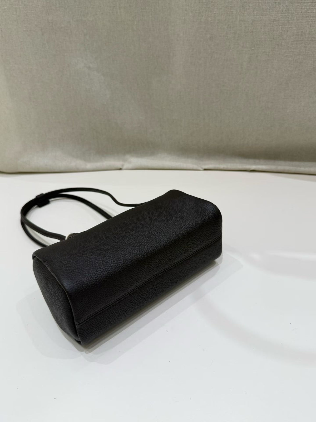 Underside view showing the black bag's stitched base