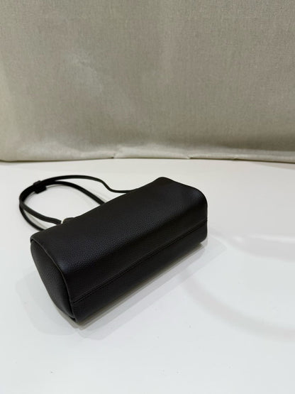 Underside view showing the black bag's stitched base
