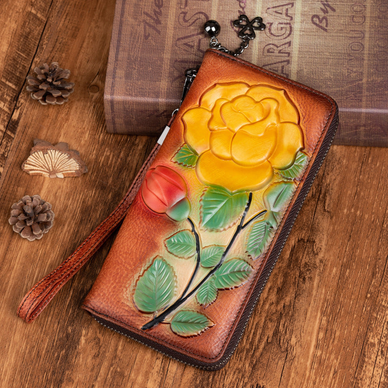 Vintage red-brown cowhide zip wallet with raised yellow flower and wrist strap