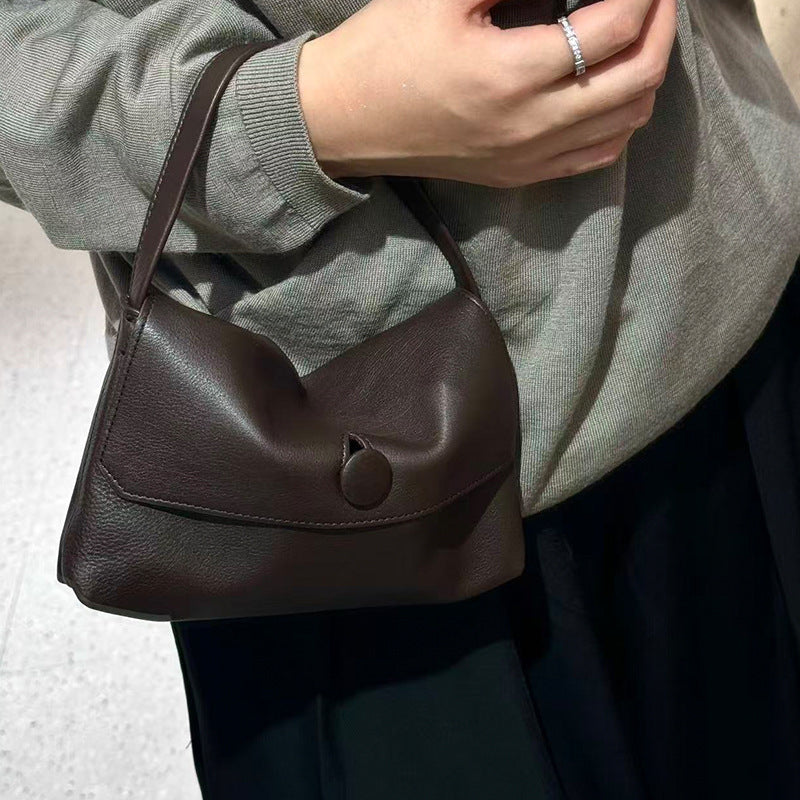 Coffee lambskin shoulder bag shown carried at the side