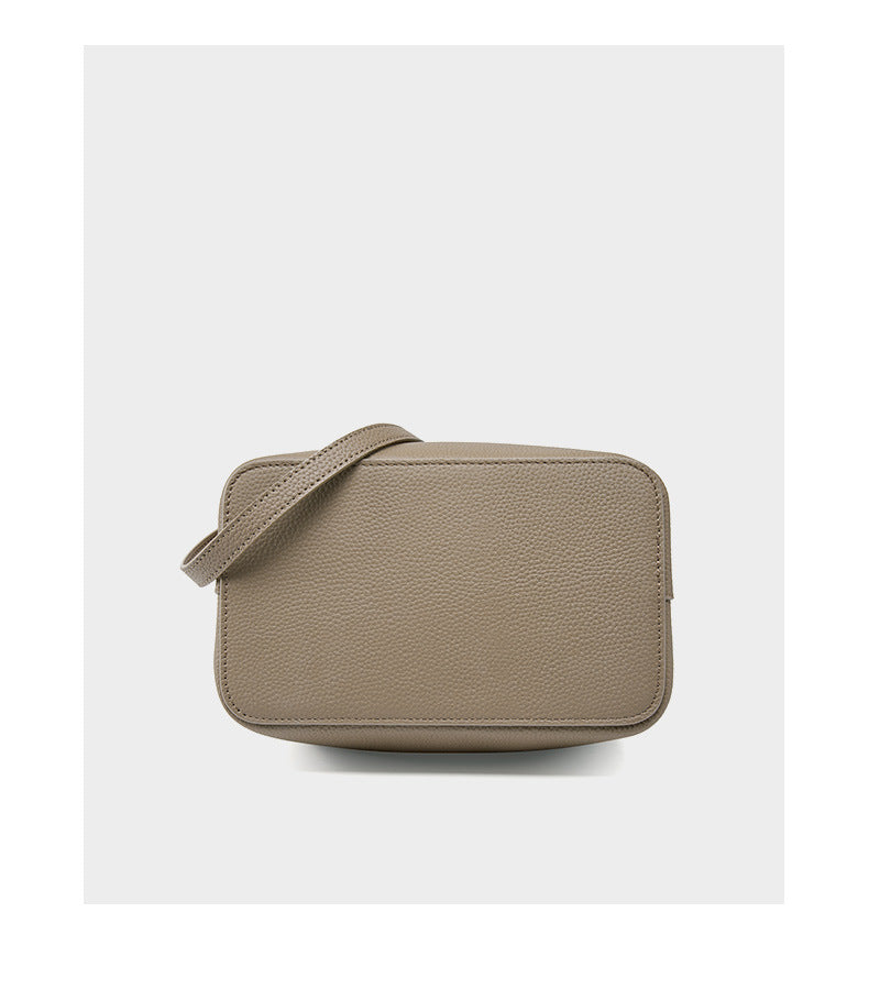 Khaki bucket bag top-down view showing strap and base