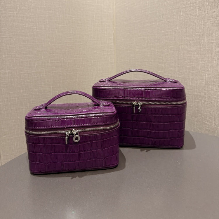 Two purple crocodile-embossed cowhide cosmetic pouches in different sizes