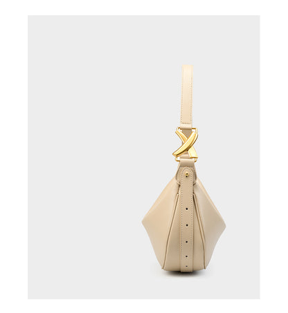 Side profile of off-white cowhide crescent underarm bag showing depth and strap rivet