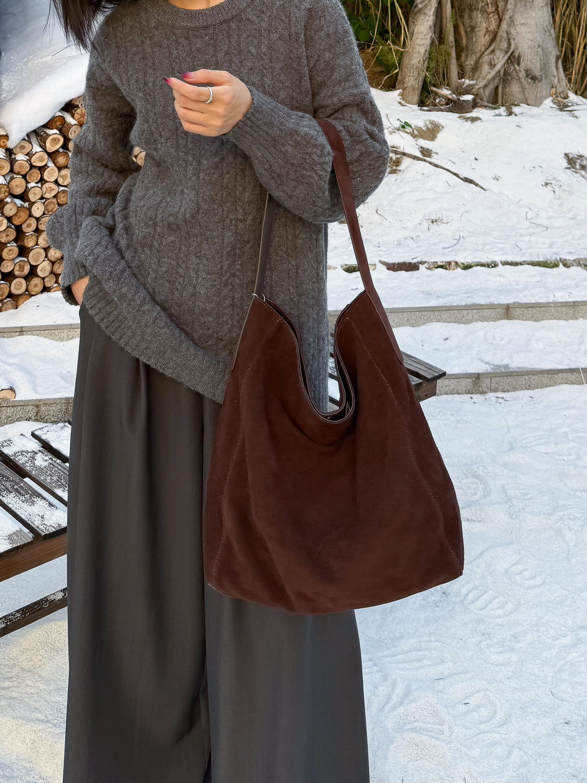 Back view of a model wearing the caramel shoulder bag