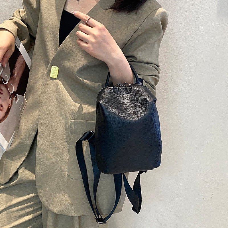 Black pebbled cowhide mini backpack worn by a model