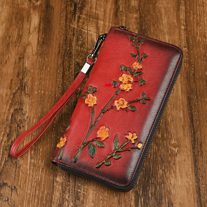 Red leather wallet with raised floral decoration and zip closure