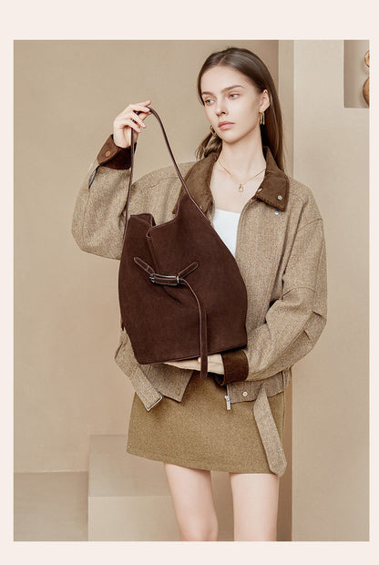 Coffee suede tote displayed by its shoulder strap