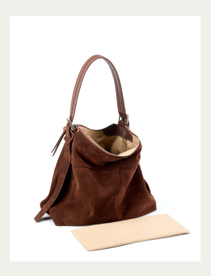 Open brown tote showing its zip closure and lined interior