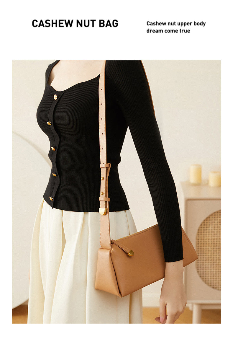 Apricot pillow crossbody bag styled with a black cardigan and white skirt