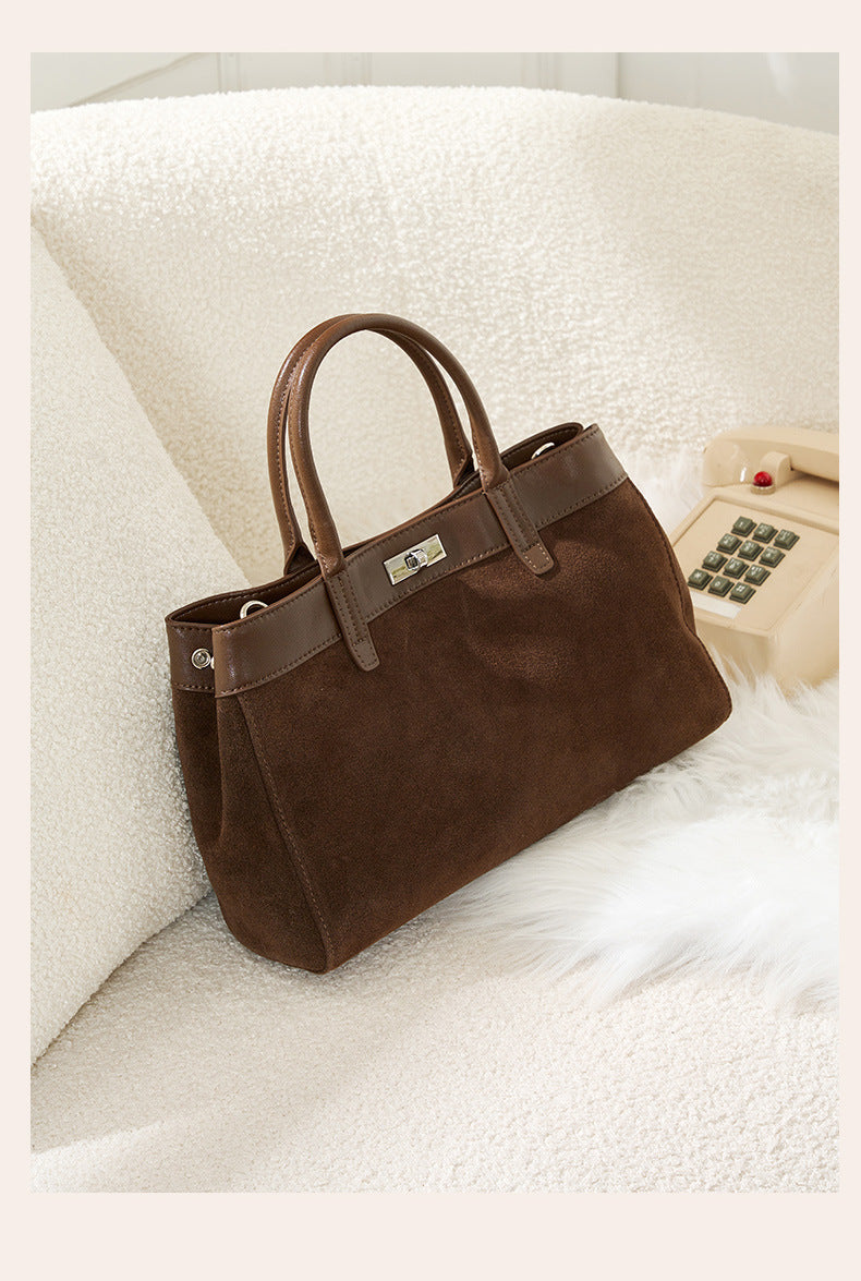 Dark brown suede shoulder bag with top handles and turn-lock detail
