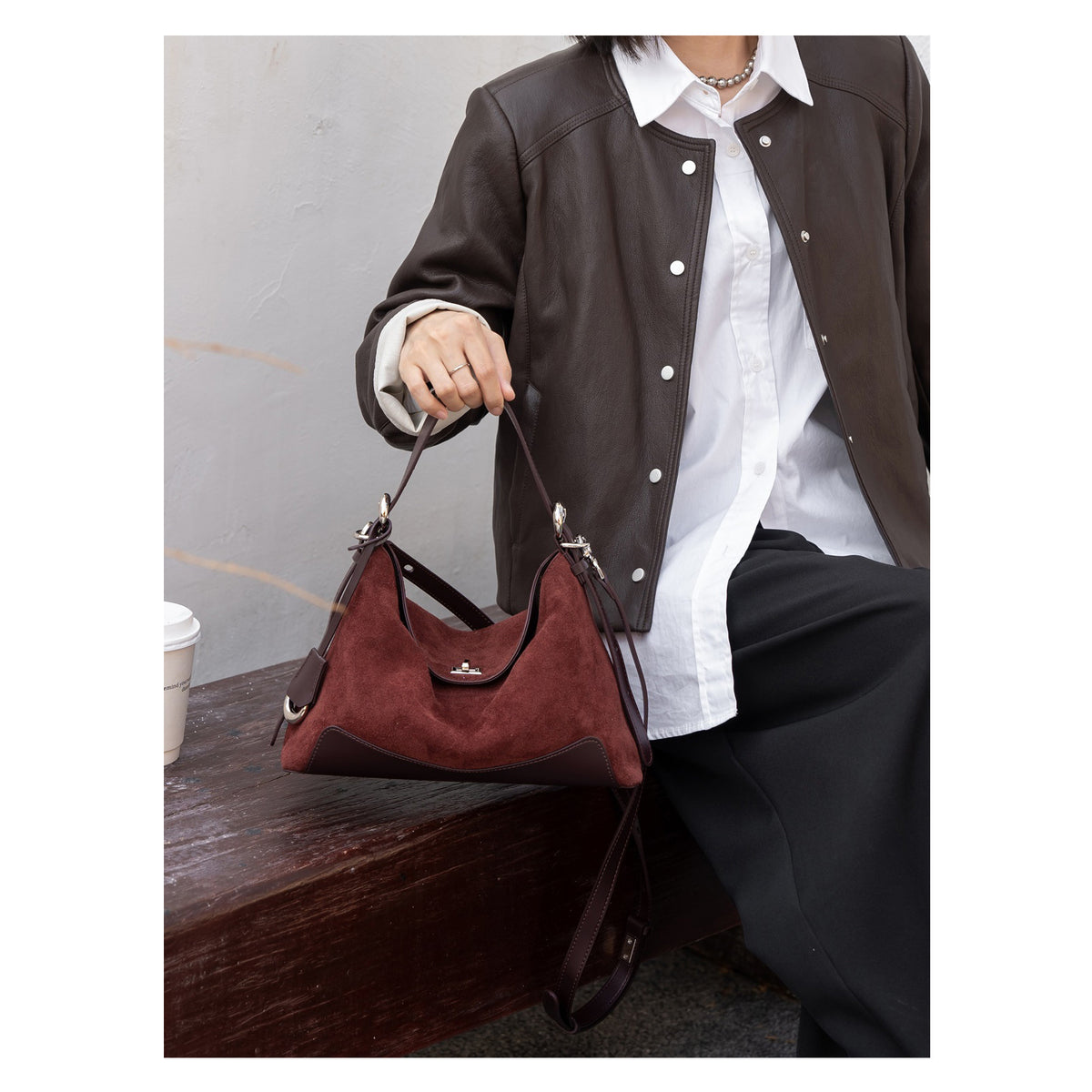 Burgundy tote shown carried by the shoulder strap