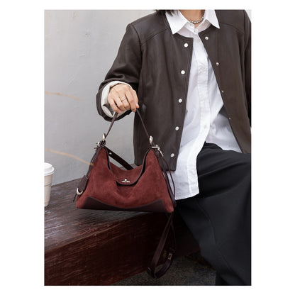 Burgundy tote shown carried by the shoulder strap