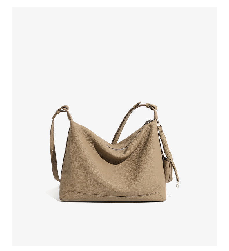 Back view of gray cowhide leather hobo bag showing adjustable strap
