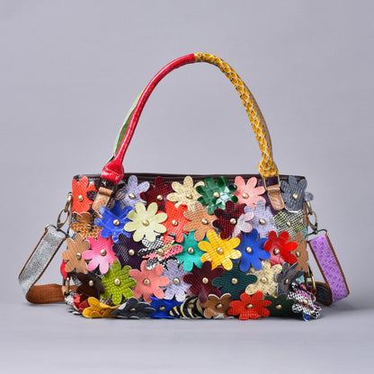 Front view of colorful leather shoulder bag with layered flower appliques