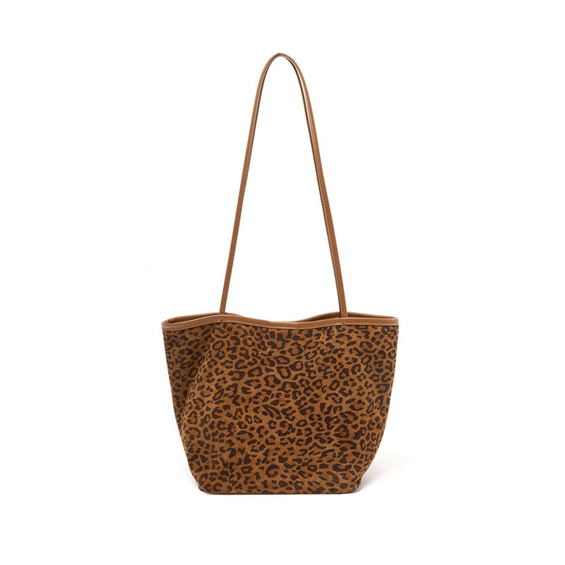 Front view of leopard print suede bucket tote with long shoulder strap