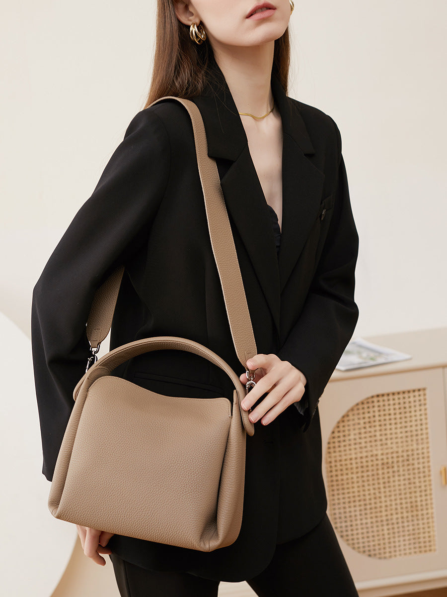Side view of pebbled cowhide crossbody bag worn on shoulder