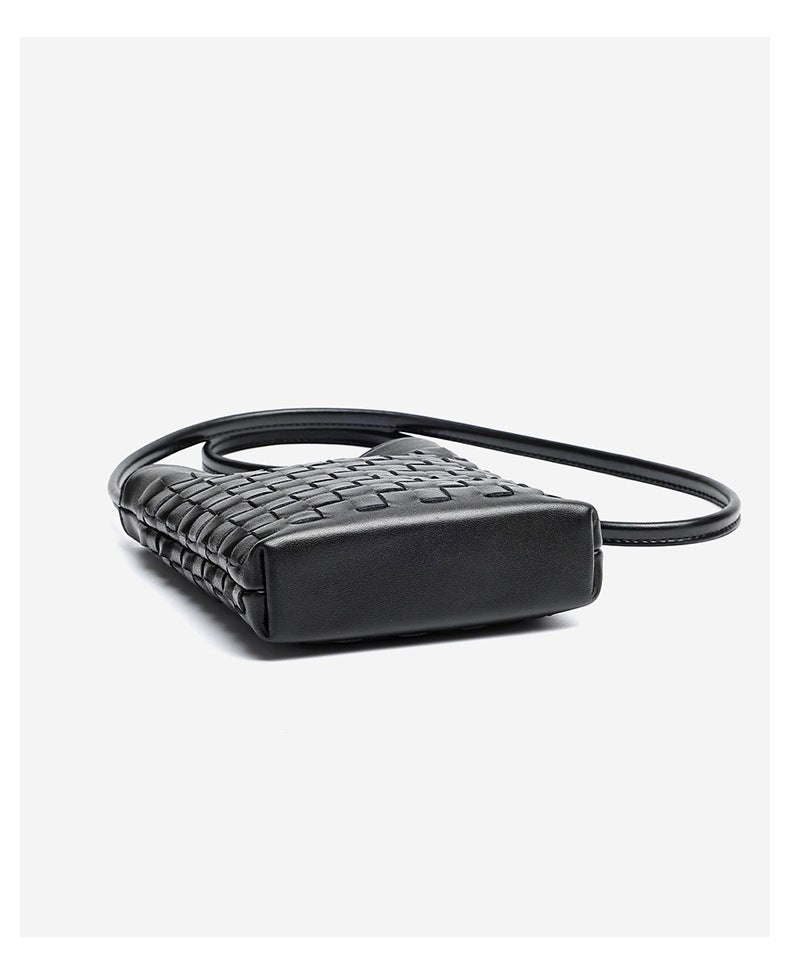 Side angle of black woven phone bag showing slim profile and leather shoulder strap