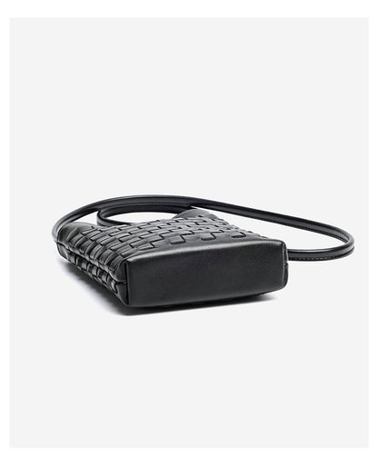 Side angle of black woven phone bag showing slim profile and leather shoulder strap