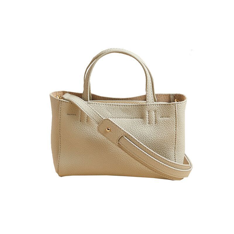 Pearl gray mini tote with detachable strap on a plain background