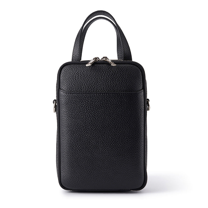 Black pebbled leather vertical phone crossbody bag shown front view with silver-tone zippers