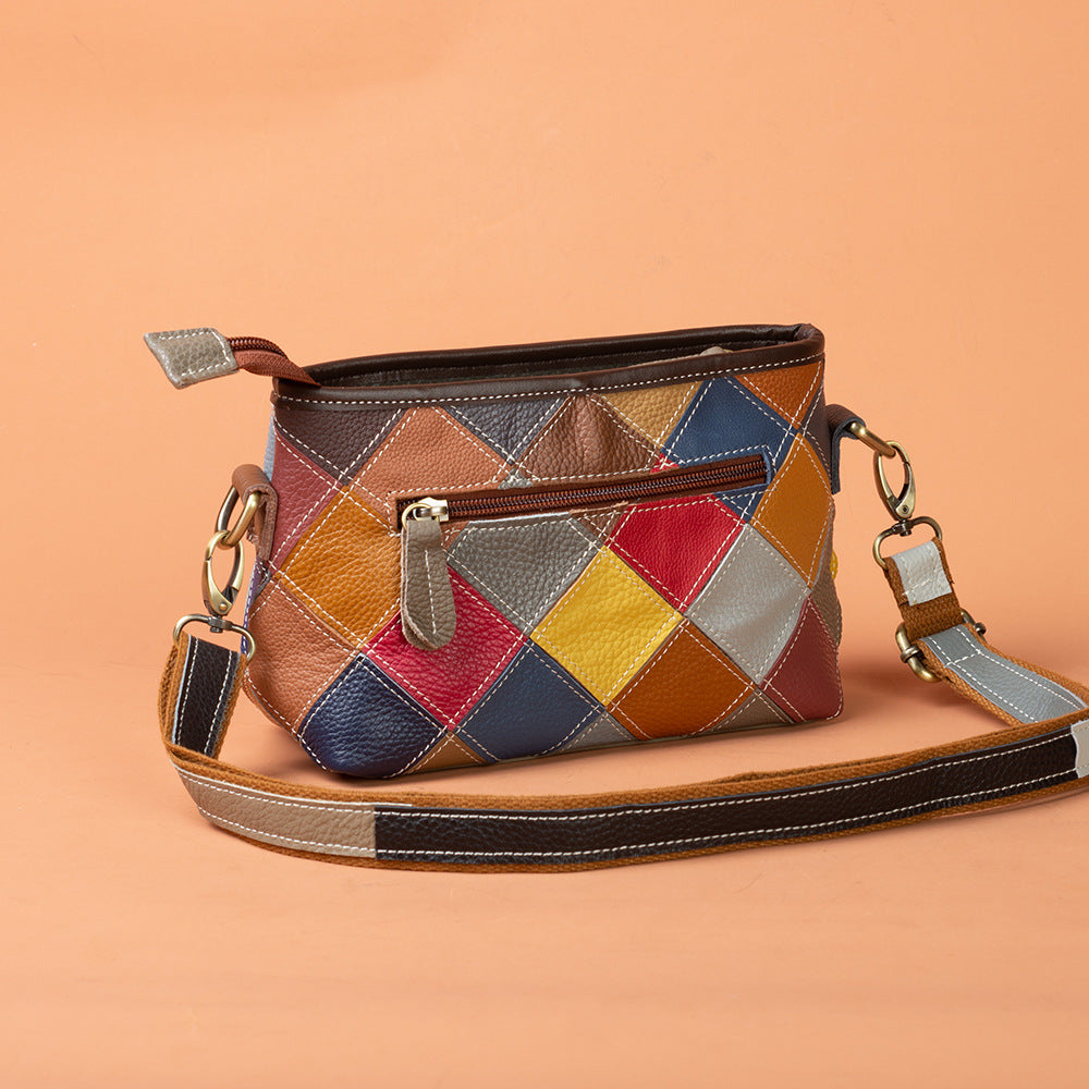 Front view of patchwork leather bag with exterior zip pocket and strap