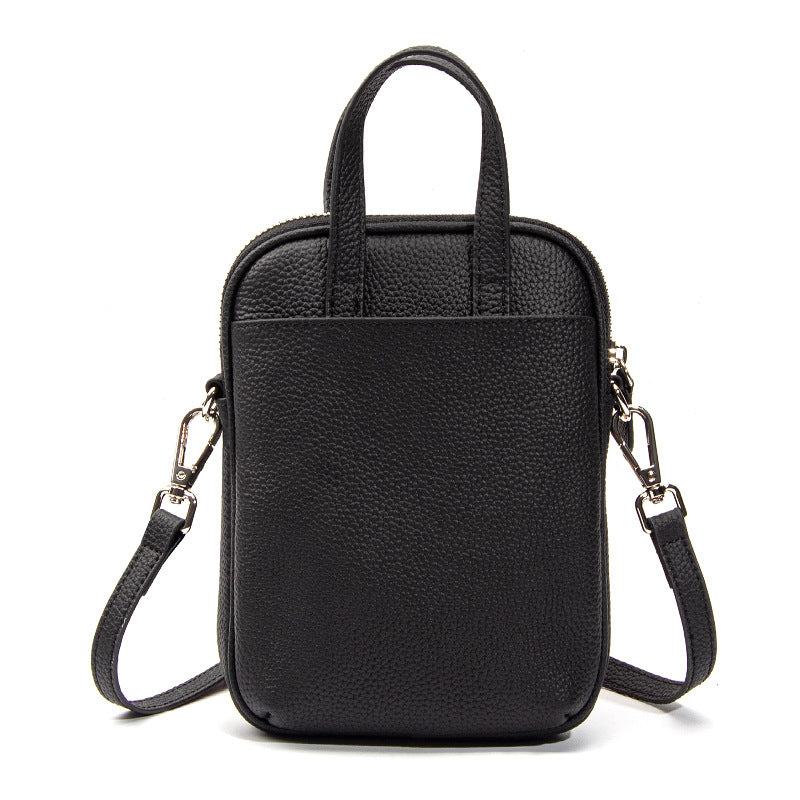 Black Mara cowhide crossbody bag back view with detachable strap attached