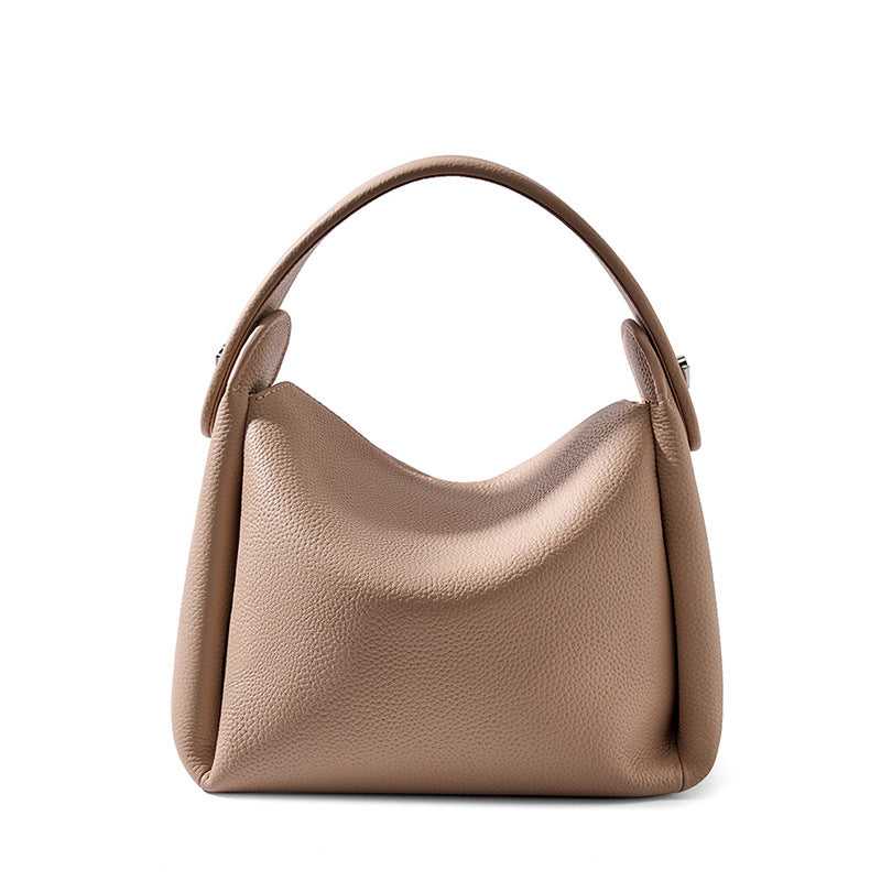 Pebbled cowhide leather crossbody bag in milk tea color on white background
