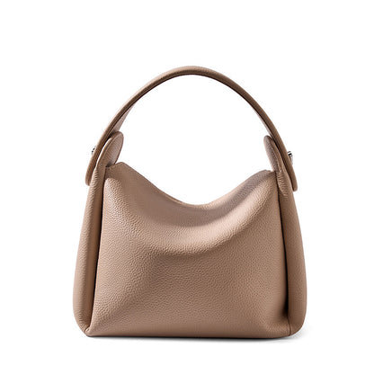 Pebbled cowhide leather crossbody bag in milk tea color on white background