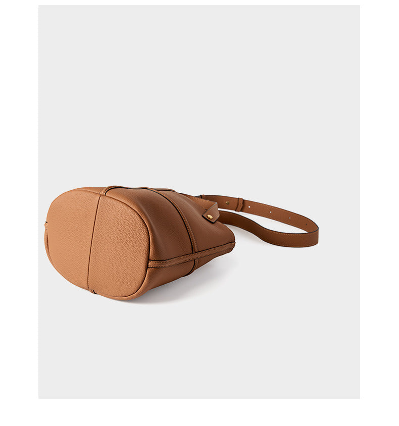 Side view of the brown bucket bag highlighting its depth