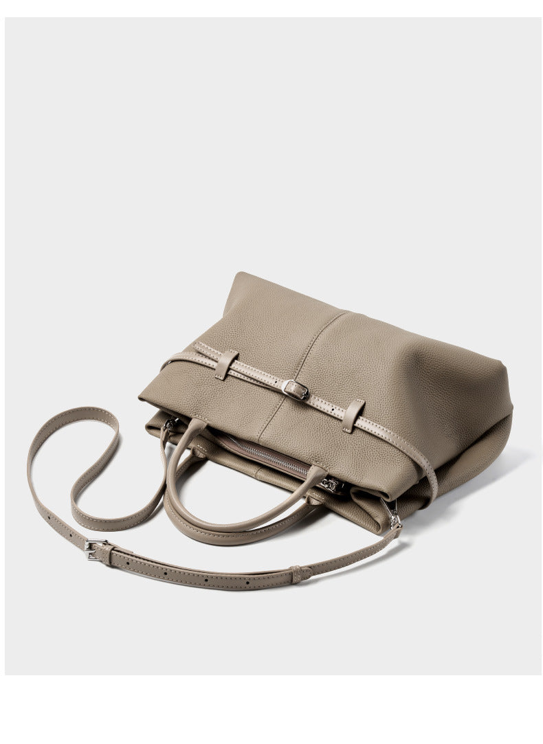Top-down view of empty elephant gray tote showing front buckle strap and interior