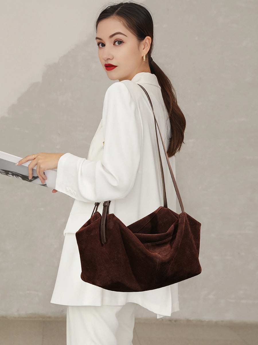 Model carrying coffee-colored tote over the shoulder