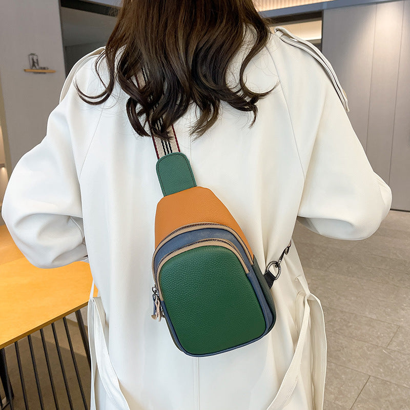 Green colorblock cowhide sling bag worn on the back