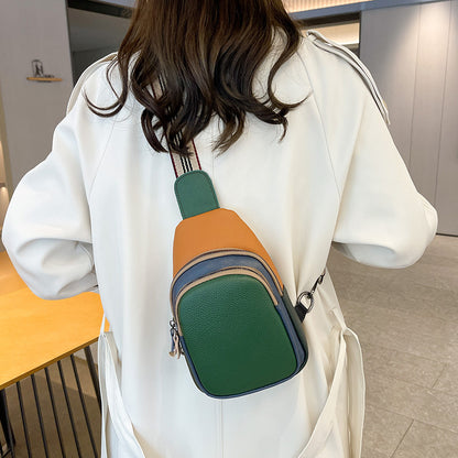 Green colorblock cowhide sling bag worn on the back