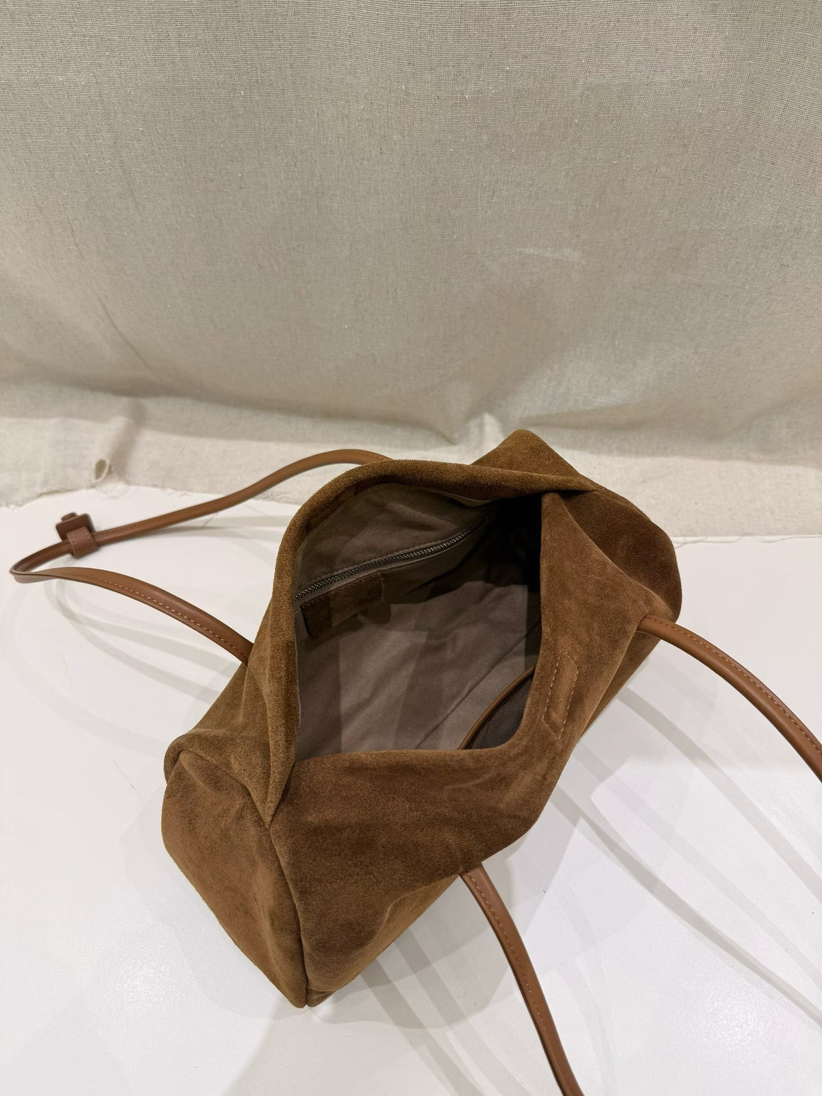 Slim side profile of the caramel shoulder tote
