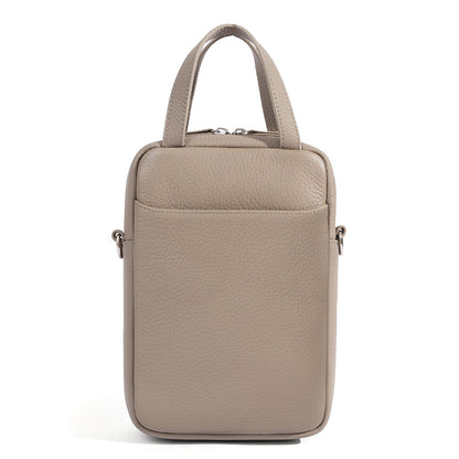 Front detail of light gray pebbled leather phone bag highlighting front slip pocket and topstitching