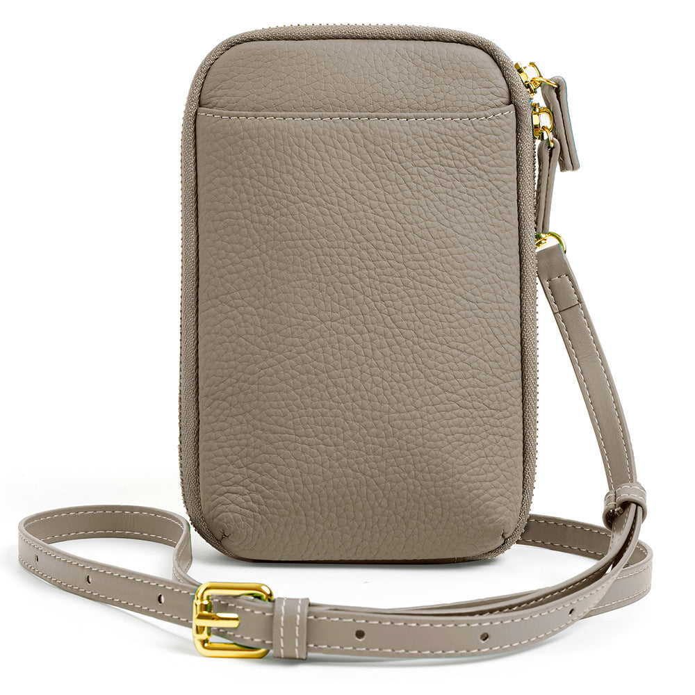Light gray pebbled leather crossbody phone bag with gold-tone buckle on white background