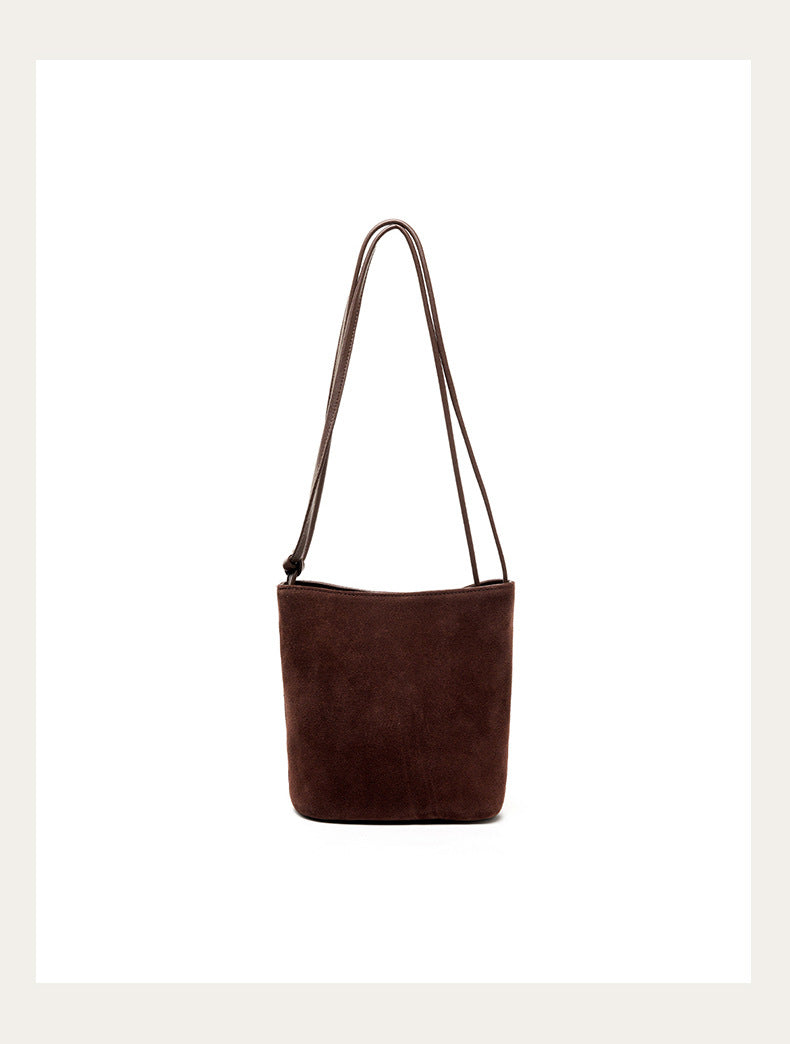 Coffee nubuck bucket bag front view on plain background