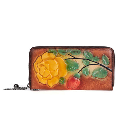 Side view of the red-brown embossed floral wallet with zipper hardware