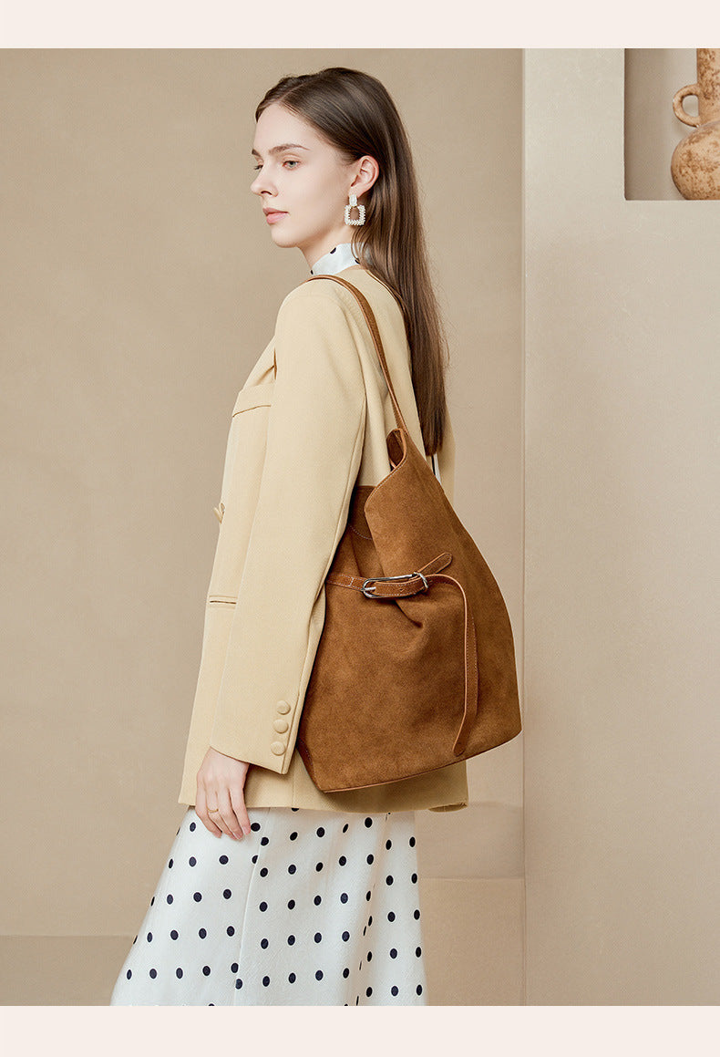 Caramel suede bucket tote shown from the side