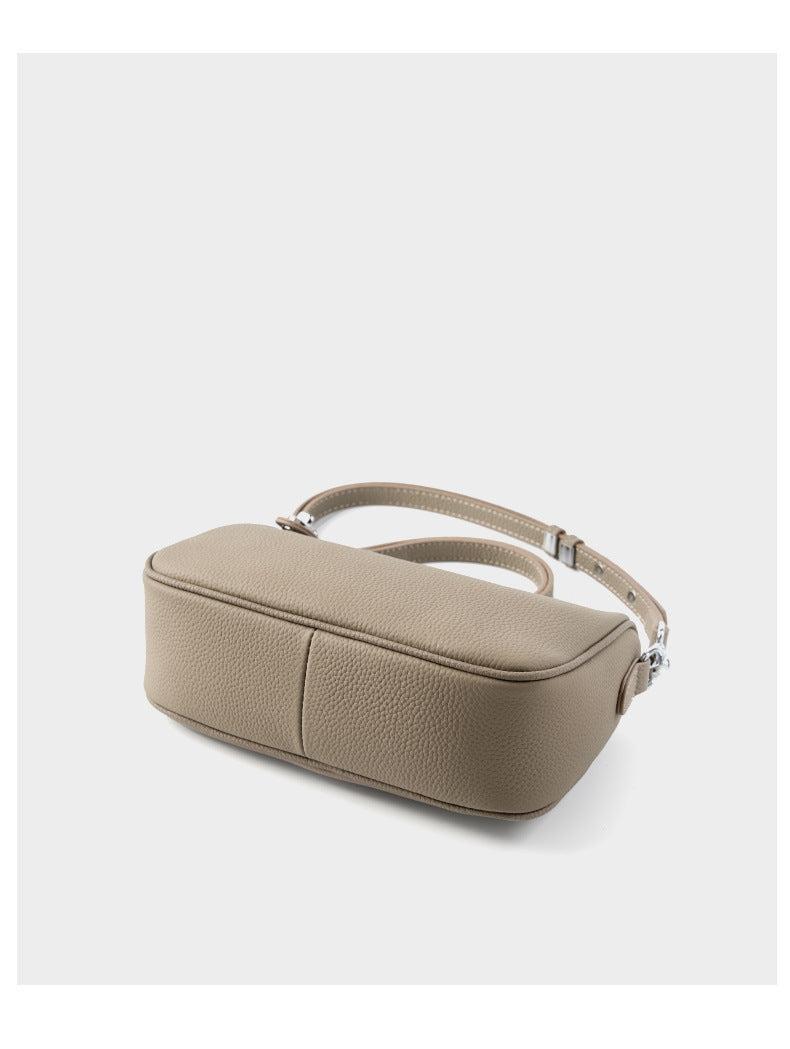 Bottom and side view of taupe bag displaying structure
