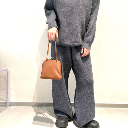 Coffee leather bag held by its shoulder straps