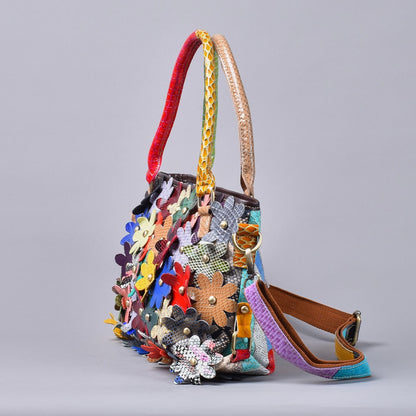 Angled side view showing floral embellishments and detachable shoulder strap