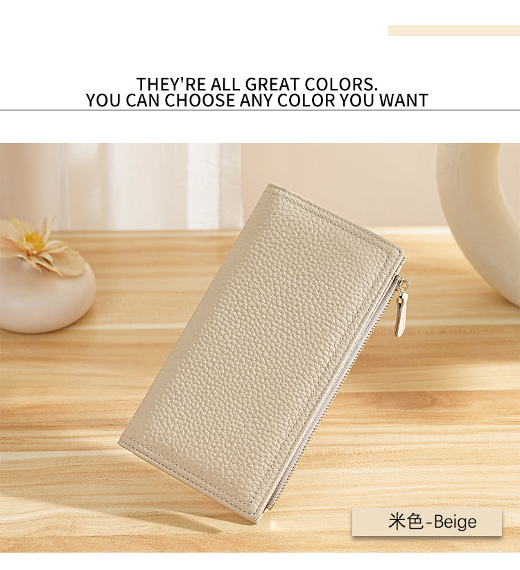 Beige long wallet displayed on a wooden surface